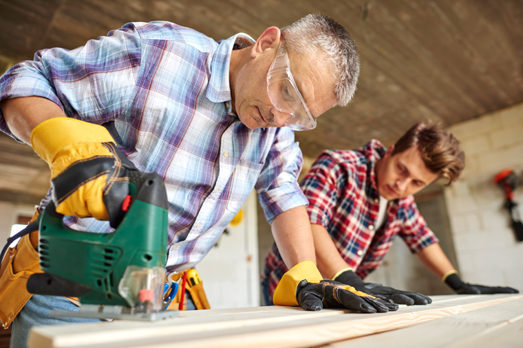 close-up-experienced-carpenter-his-younger-employee